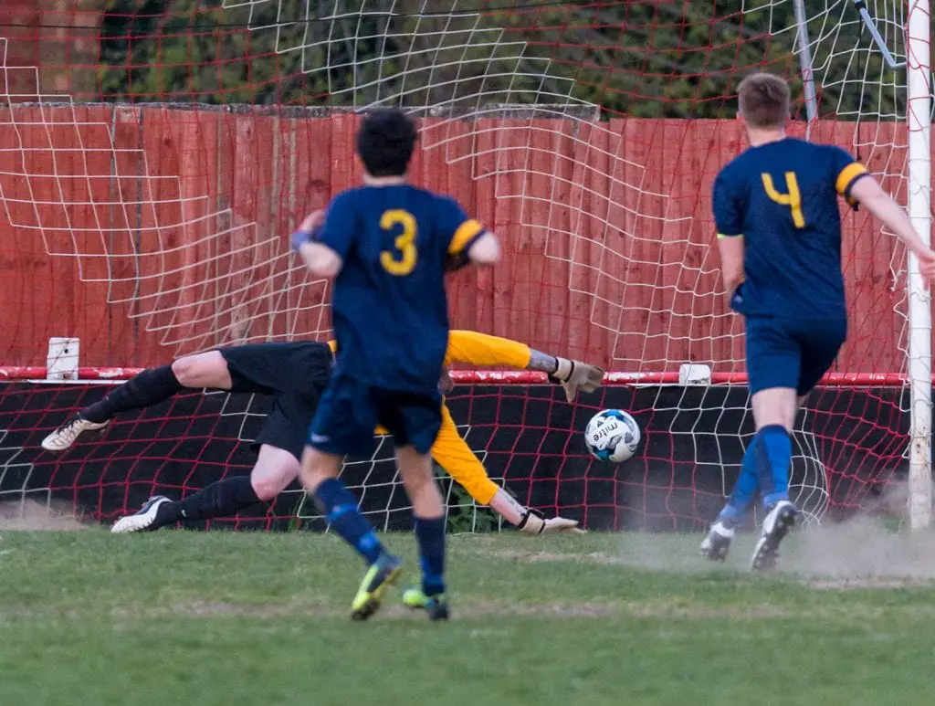 Binfield Club Athletic captain Tom Williams scores from the penalty spot. Photo: Neil Graham.