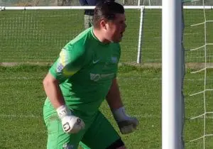 Liam Vaughan roars after saving a penalty for Binfield FC. Photo: James Green.