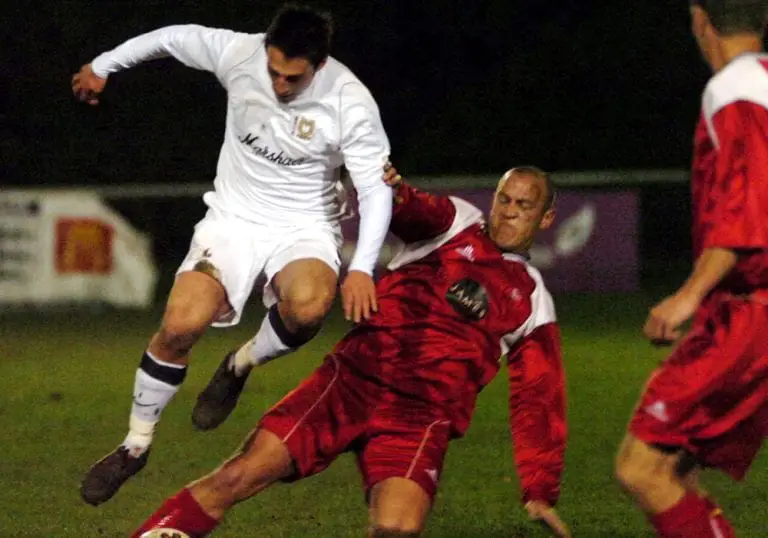Bracknell Town's Chris Geary challenges an MK Dons player in the County Cup. Photo: Get Reading.