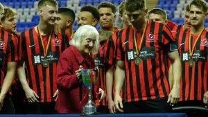 Finchampstead receive the trophy from Margaret Wrigley. Photo: Andrew Batt